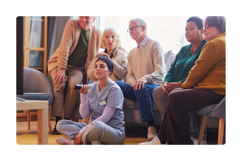 Care home staff setting up films for residents